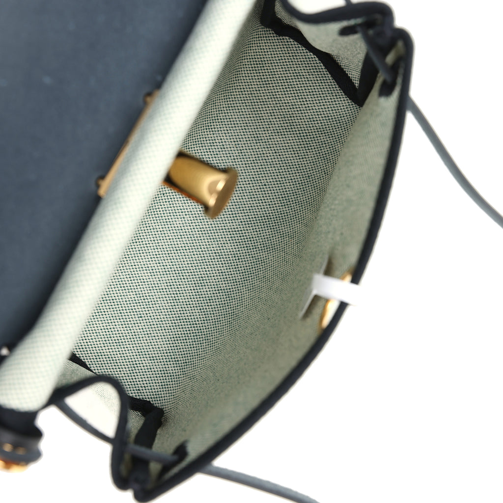 حقيبة Herbag Zip 20 ميني بلون إيكرو وأخضر موين من قماش Toile H وجلد Vache Hunter الأسود مع قطع معدنية من ذهب