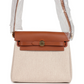 حقيبة Herbag Zip 20 ميني من قماش Toile H باللونين الإيكرو والبيج مع جلد Vache Hunter باللون الفوف وأجزاء معدنية من ذهب