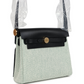 حقيبة Herbag Zip 20 ميني بلون إيكرو وأخضر موين من قماش Toile H وجلد Vache Hunter الأسود مع قطع معدنية من ذهب